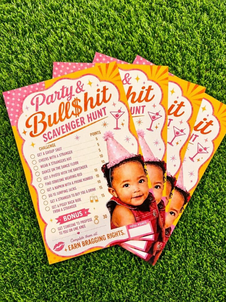 Scavenger hunt game cards with a baby's photo resting on green artificial grass.