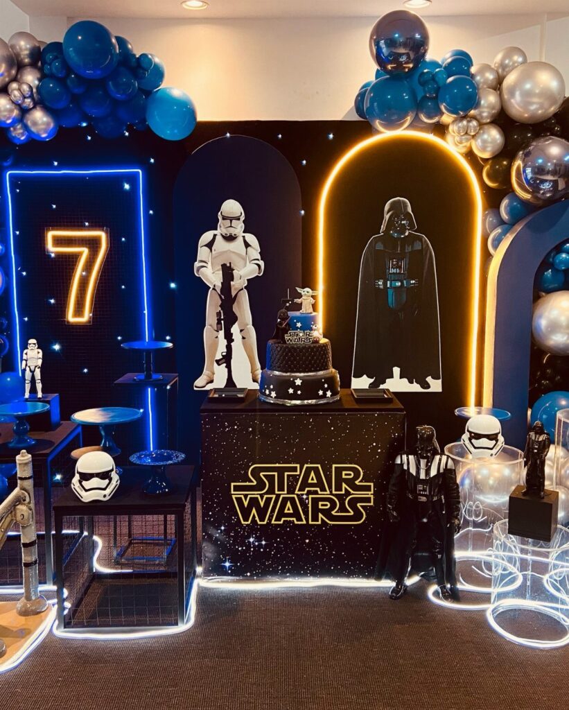 Star Wars themed birthday party setup with neon lights, balloons, and character figures.
