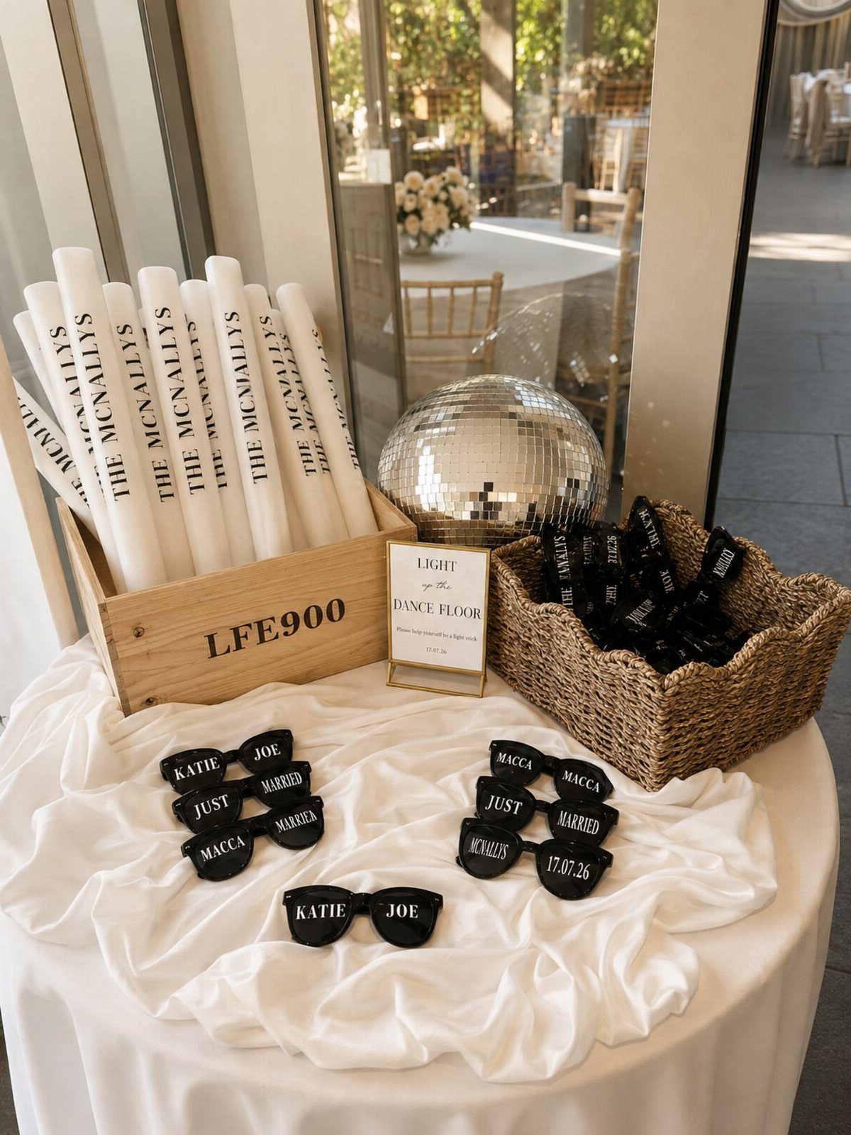 Wedding dance floor props including personalized glow sticks, sunglasses, and a disco ball.